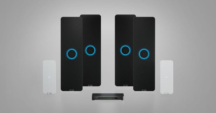 A Nureva HDX 4 bar + 2 pod configuration on a neutral gray background. It includes 4 black audio bars with glowing blue circles, 2 white microphone pods and 1 black system hub.