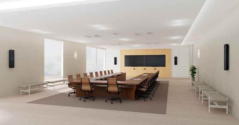 Modern conference room with a Nureva HDX 4 bar + 2 pod audio system, a dual display and a large boardroom table and chairs, illustrating the most comprehensive and feature-rich setup for full-room audio conferencing with in-room audio and the hardware involved when planning conference room audio costs and deployment.