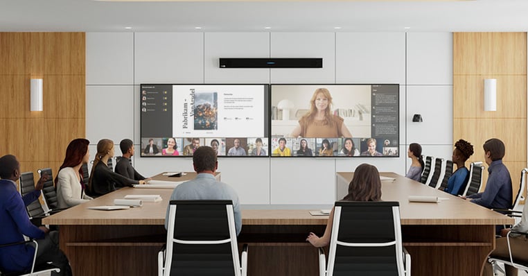 Conference room with a wall-mounted Nureva HDL410 audio conferencing system installed above dual displays for hybrid meetings, illustrating a professional full-room audio setup for extra-large spaces.