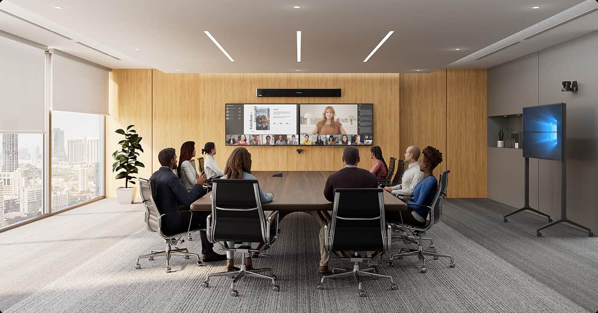 Modern conference room with people attending a hybrid video meeting on a large wall-mounted display and wall mounted HDL310 audio system