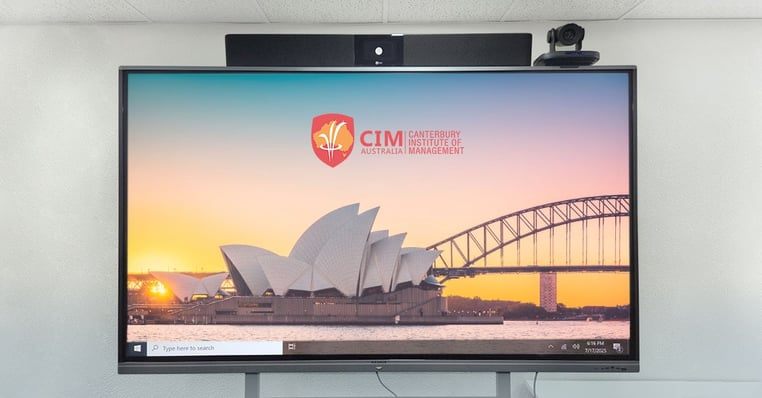 Large interactive display showing the Canterbury Institute of Management logo and a scenic image of the Sydney Opera House and Harbour Bridge. A Nureva HDL200 audio system and videoconferencing camera are mounted above the display.