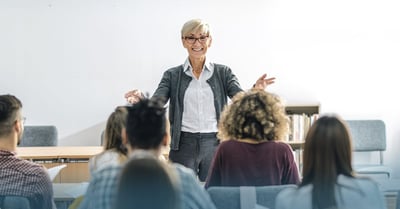 Professor teaching in front of a hybrid distance education class