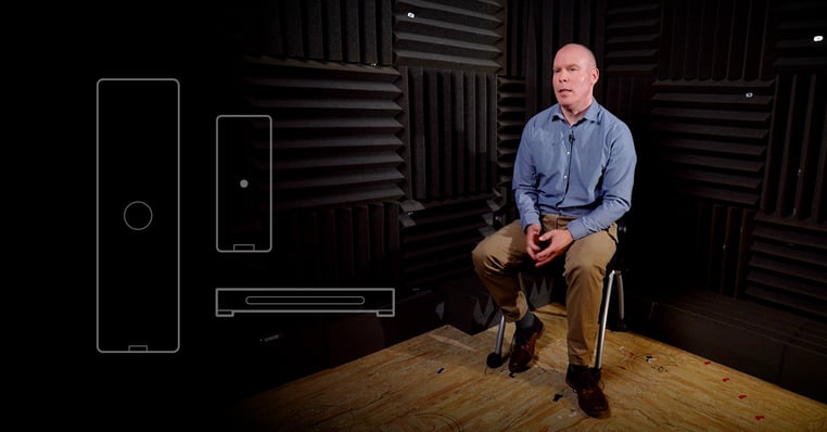 Nureva VP Neil Bullock sits while being interviewed in a sound booth with an illustration of HDX series components overlayed on the image.