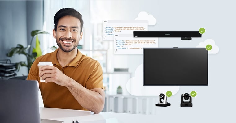 IT pro sitting at a computer monitoring displays and cameras with Nureva Console