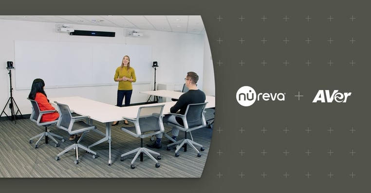 Three people in a meeting room demonstrating camera tracking with Nureva and AVer