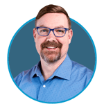 Male in a blue shirt smiling inside a blue circle.