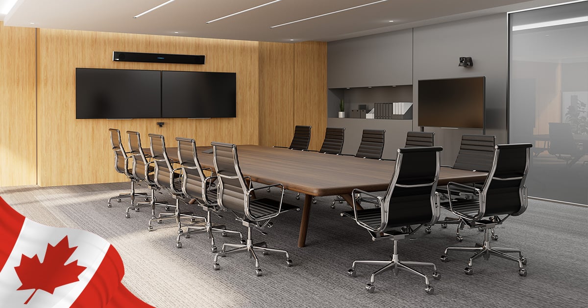 Modern boardroom equipped with Nureva HDL310 audio conferencing system mounted above dual displays for clear sound in large meeting spaces.