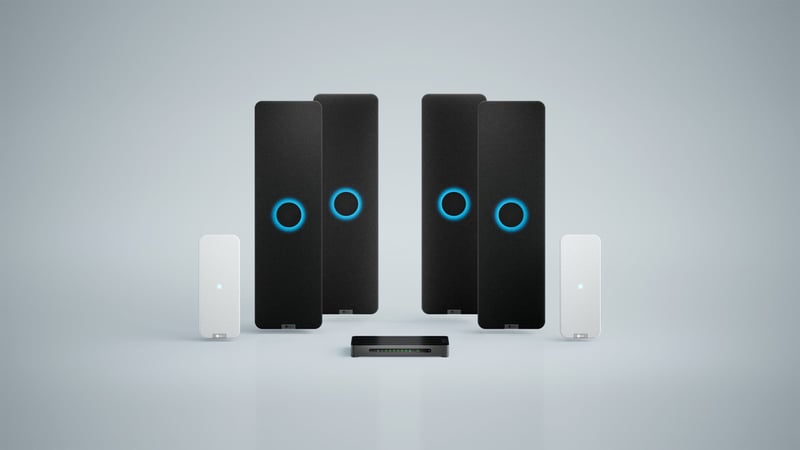 Nureva HDX system with four black audio bars, two white microphone pods and a system hub for large meeting spaces.