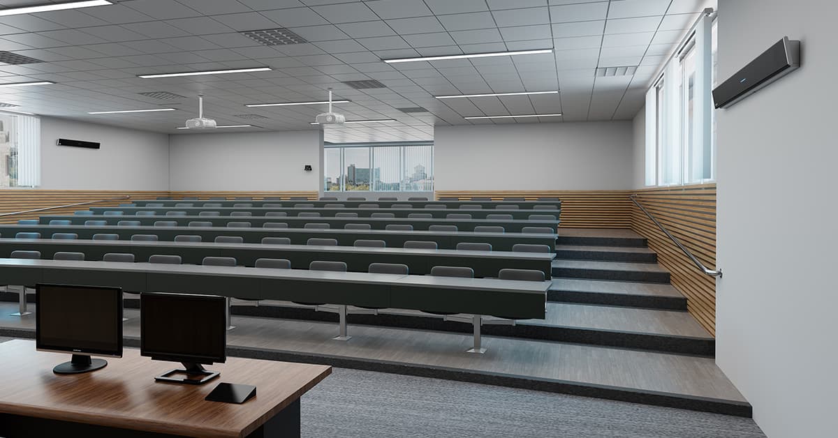 Lecture hall with Nureva HDL410 setup for full-room microphone coverage, providing clear audio pickup across tiered seating for hybrid learning and presentations.