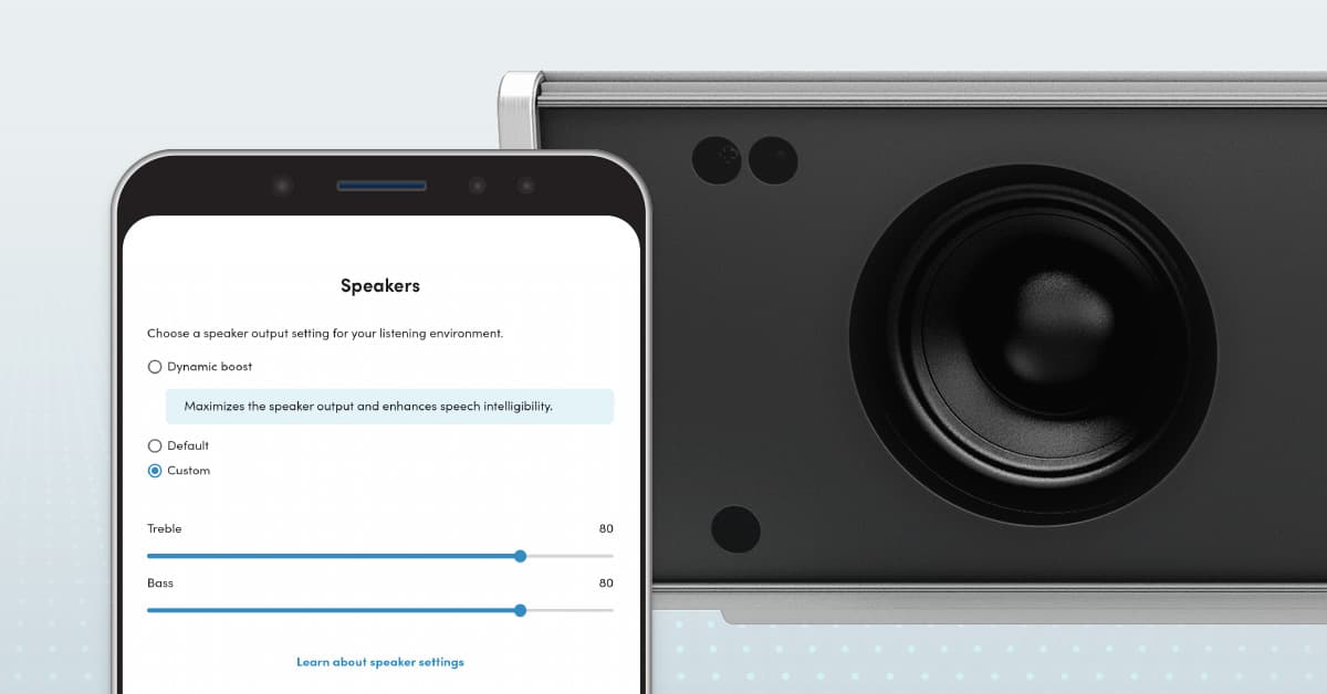 Close-up of a Nureva HDL series audio bar speaker alongside a mobile device showing advanced speaker settings, illustrating customizable audio performance features.