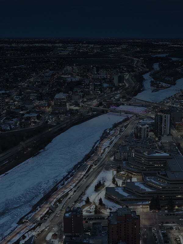 Aerial night view of Zurich city along a frozen river, representing the Nureva HDX on Tour stop in Zurich.