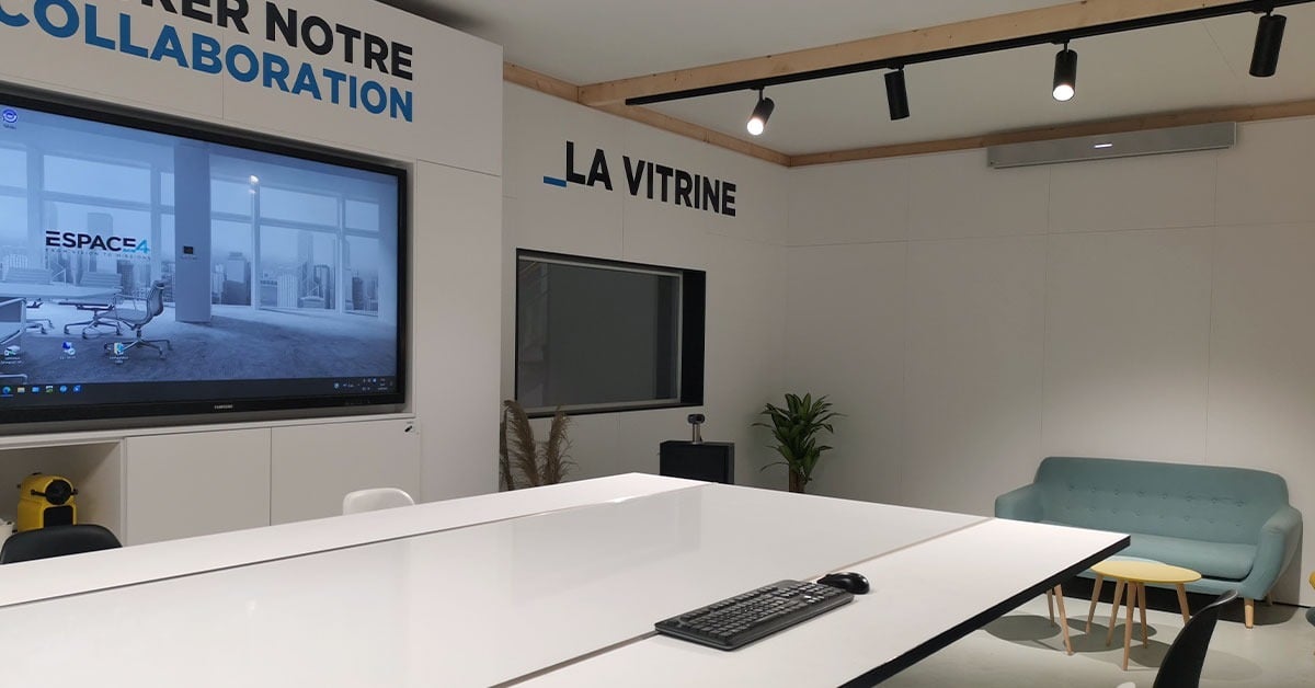 Espace4 La Vitrine modern meeting space in France with a large display wall showing the Espace4 brand, Nureva audio system and flexible seating for hybrid collaboration.