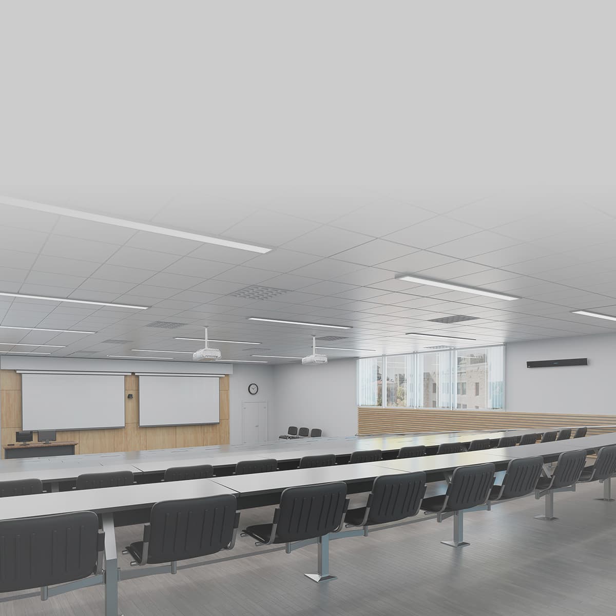 Empty university lecture hall with rows of fixed seating and a Nureva HDL audio system for hybrid learning environments.
