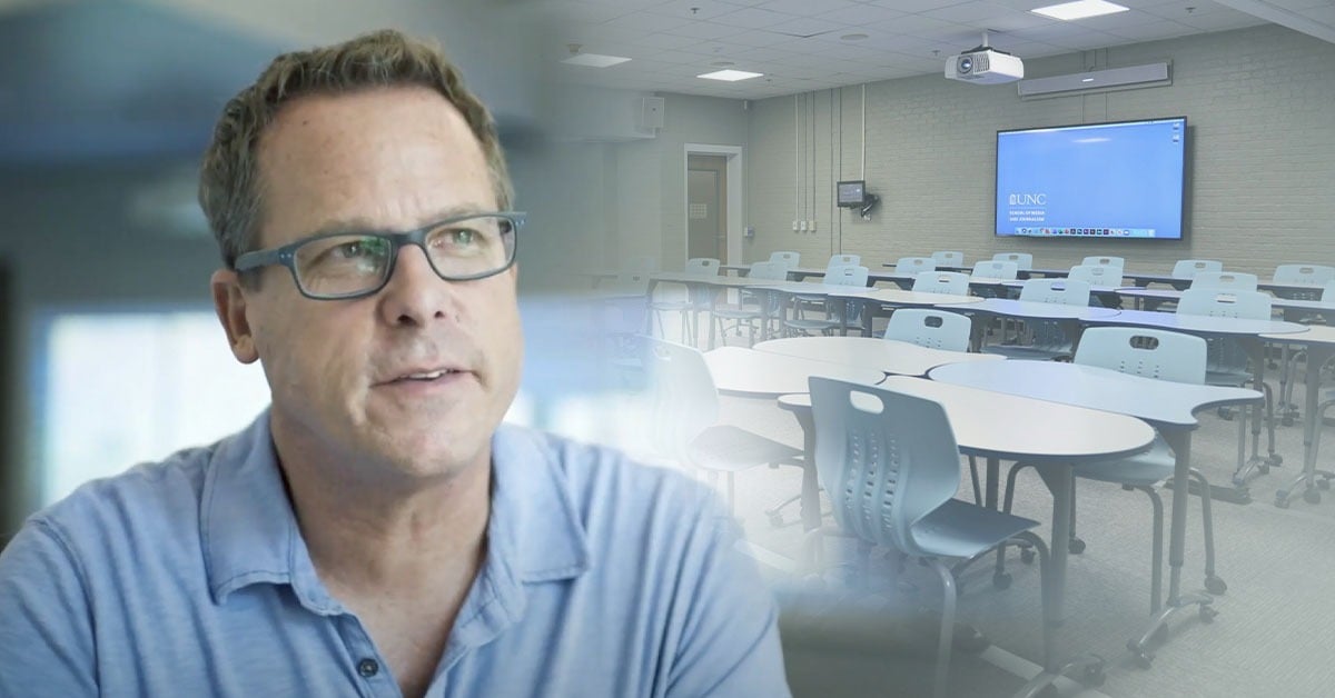 Gary Kayye of the University of North Carolina School of Journalism pictured alongside a Nureva-equipped hybrid classroom with flexible seating and a wall-mounted display.