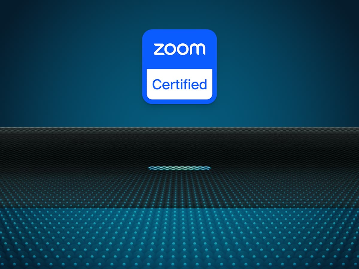 Close-up of a Nureva microphone and speaker bar against a dark blue dotted background with the Zoom Certified badge prominently displayed above, indicating certification for Zoom Rooms.