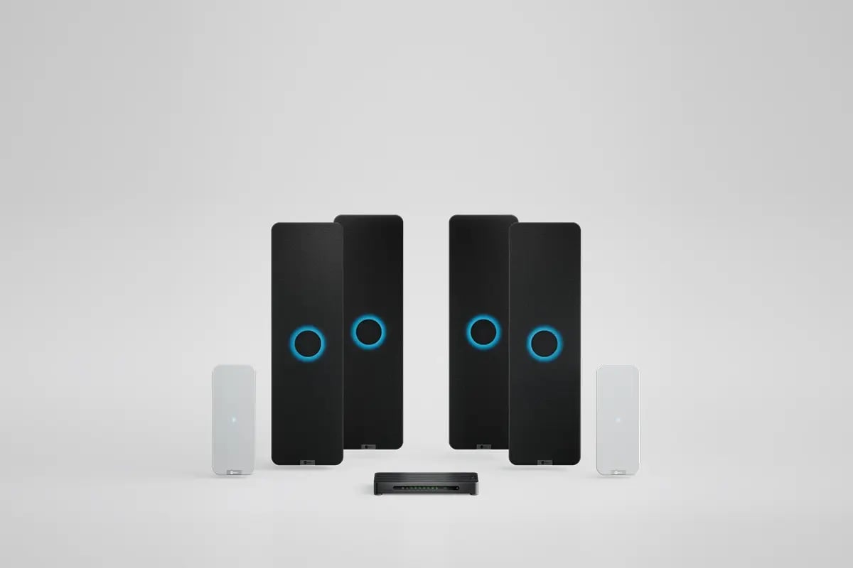 Nureva HDX system with four black audio bars, two white microphone pod and a system hub for large meeting spaces.