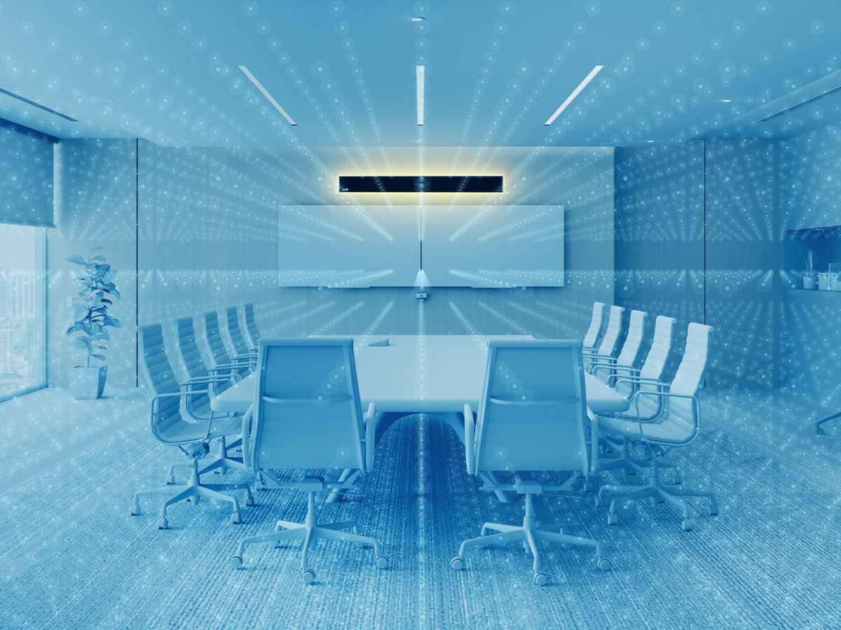 Large modern conference room with table, multiple chairs, dual displays, and Nureva HDL310 audio conferencing system mounted on walls, featuring Microphone Mist technology for full-room sound coverage and immersive audio experience.