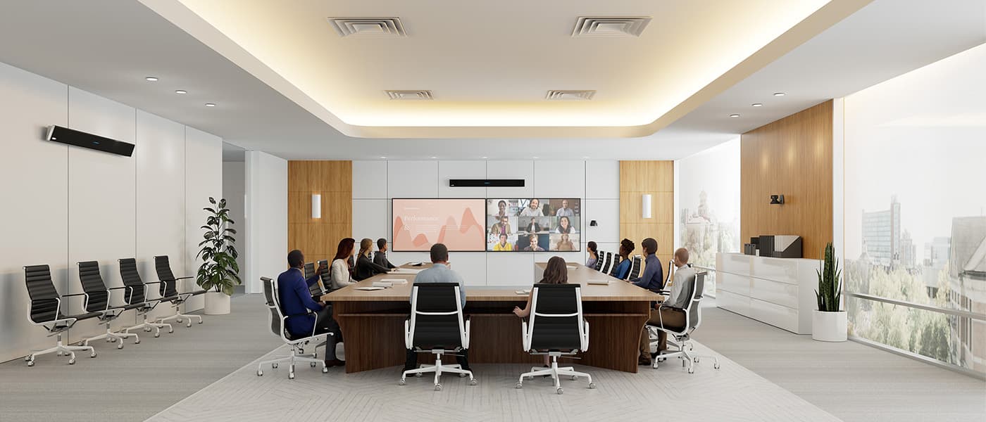 Extra-large Microsoft Teams Room boardroom featuring a Microsoft-certified Nureva HDL410 audio conferencing system mounted above dual displays running the Teams Rooms front row layout, with executive in-person participants seated around a boardroom table and remote attendees shown in gallery view.