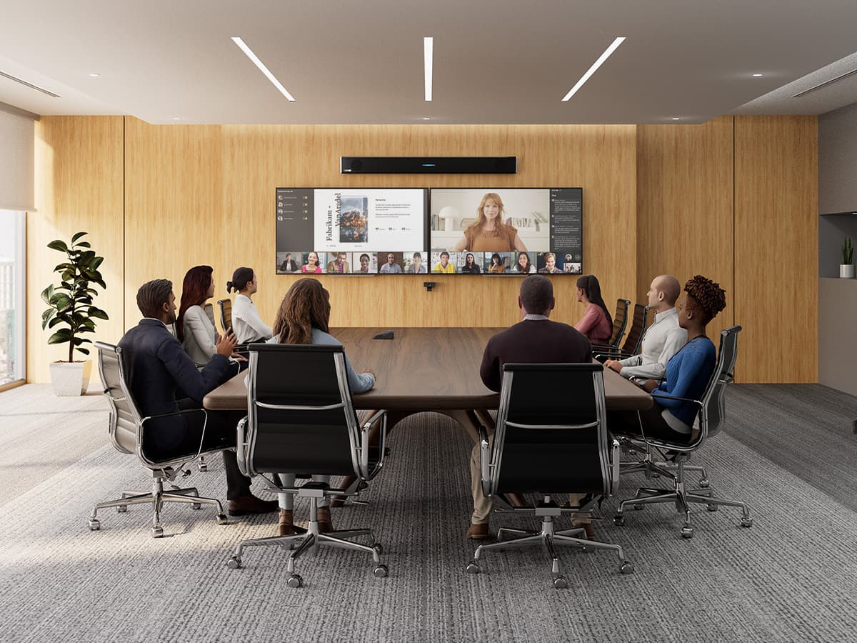 Modern hybrid work boardroom configured as a Microsoft Teams Room, featuring a Microsoft-certified Nureva HDL310 audio conferencing system mounted above dual displays showing a Teams meeting in progress, with diverse in-person participants collaborating around a table with remote participants.