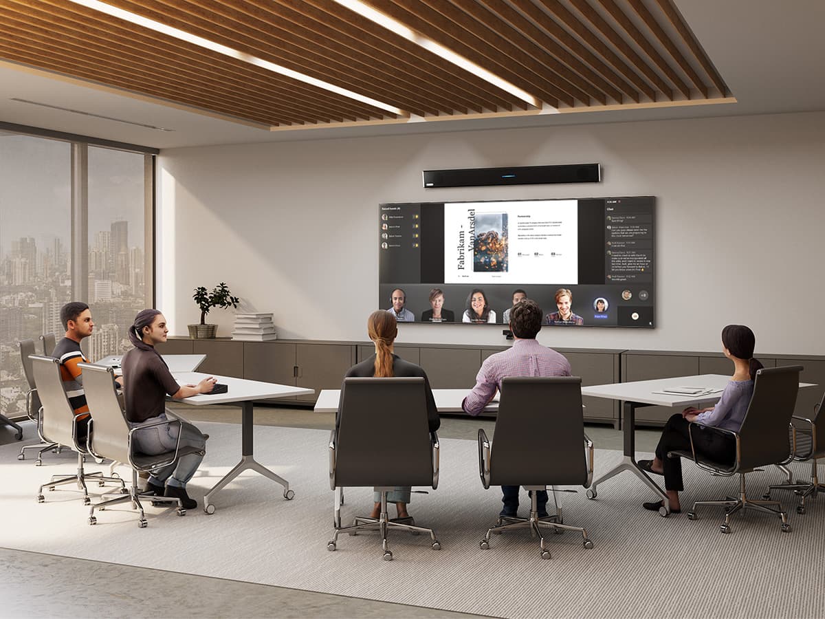 Microsoft Teams Room featuring a Microsoft-certified Nureva HDL310 audio conferencing system with spatial audio support, mounted above a wall display running a Teams meeting with active speaker view, while in-person participants collaborate at parallel meeting tables in a modern boardroom.