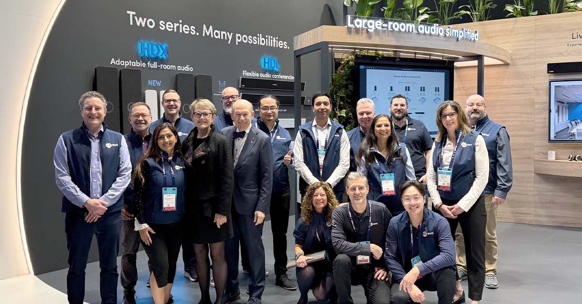 A group of 17 Nureva team members pose together at the Nureva ISE 2026 stand. Behind them are displays labeled HDX and HDL, along with signage promoting adaptable and flexible audio solutions.