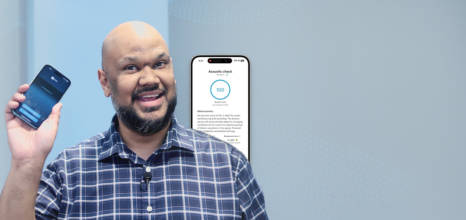 James Peters of Nureva holding a phone with Nureva App acoustic check interface