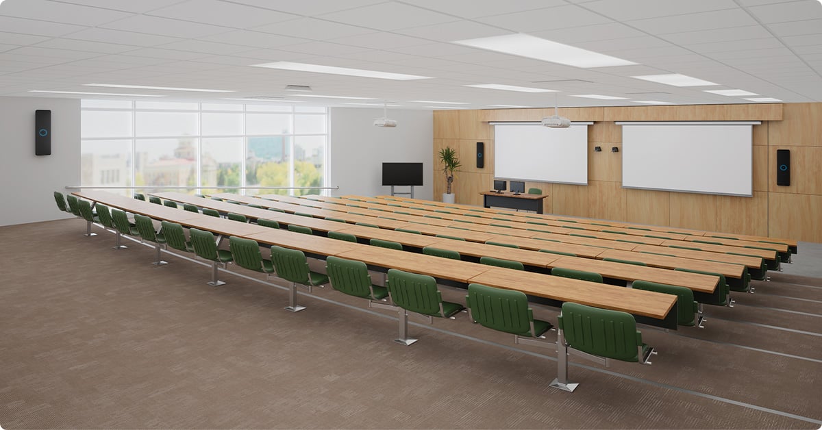 Large lecture hall with Nureva HDX in 4-bar, 1-pod setup and dual screens for clear sound coverage.