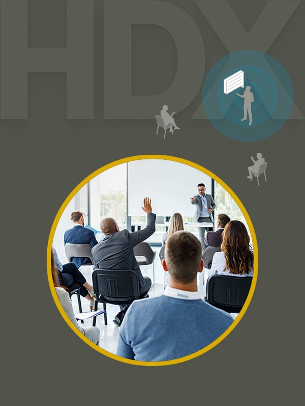 Graphic illustrating Nureva HDX series with Adaptive Voice Lift feature, showing a presenter speaking to an audience in a modern meeting room, enabling clear voice amplification for hybrid collaboration.