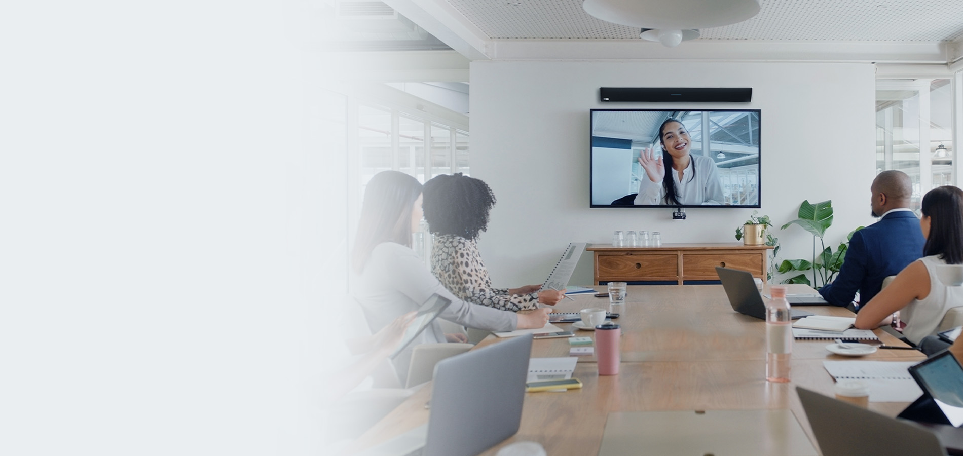 Team using a Nureva HDL310 audio conferencing system in a meeting room with a remote participant