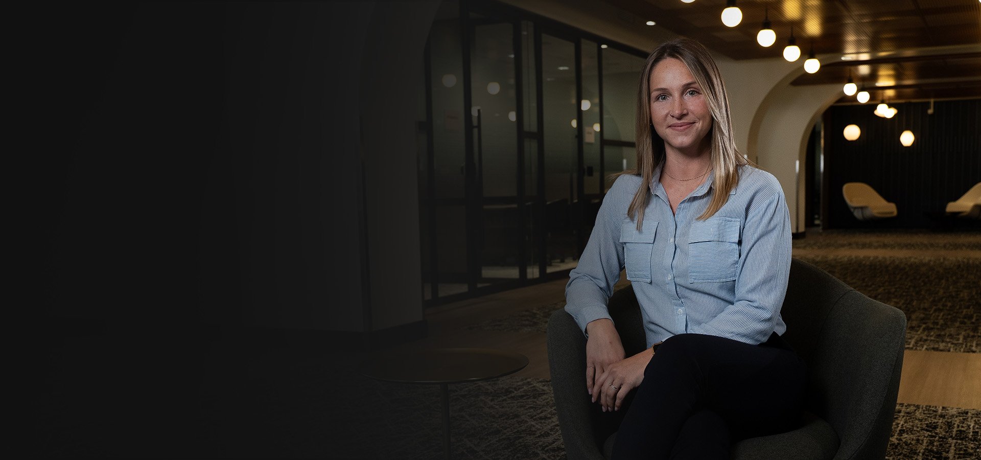 Team member at Nureva sitting in a chair in modern office space