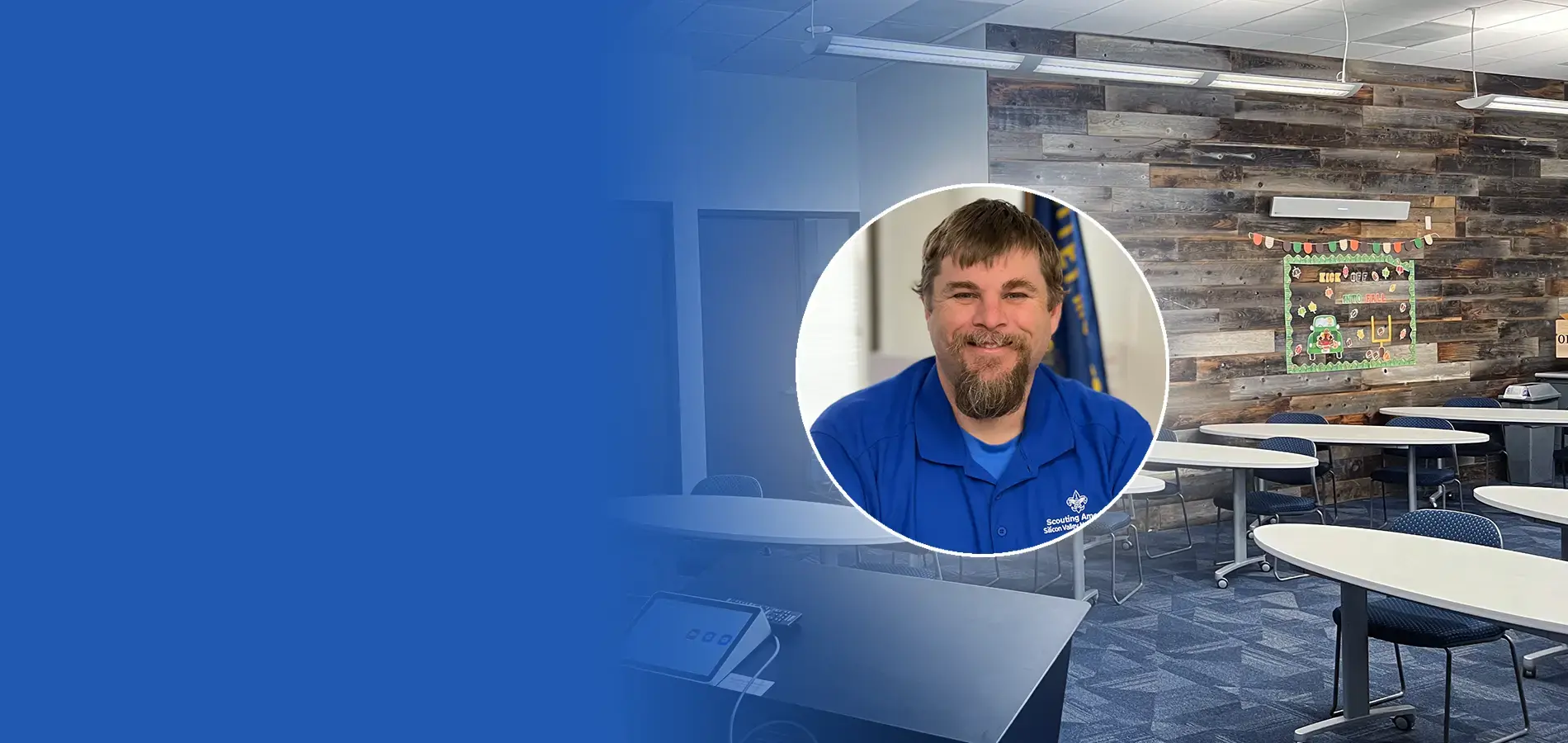 Wide-format view of a Scouting America training room with Nureva HDL audio installed, featuring a staff member and flexible group seating.